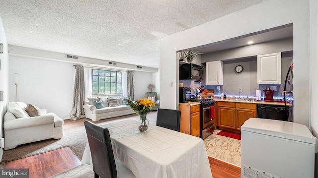 3801 Swann Rd Unit 101, Suitland, MD 20746 - dining space featuring a textured ceiling and wood finished floors
