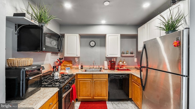 3801 Swann Rd Unit 101, Suitland, MD 20746 - kitchen with black appliances, a sink, white cabinets, and brown cabinets