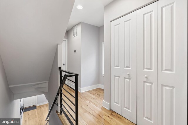 stairway featuring visible vents, wood finished floors, and baseboards