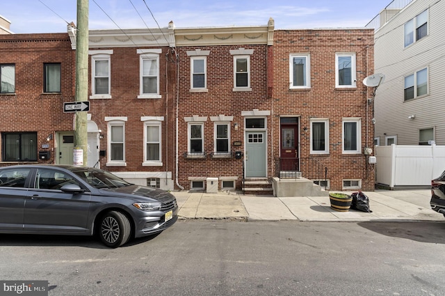 townhome / multi-family property with brick siding and entry steps