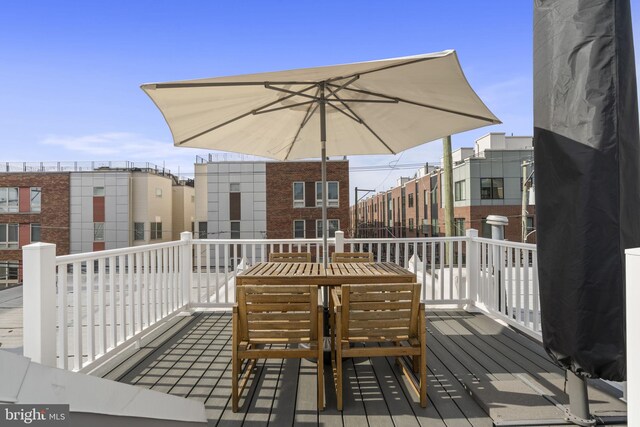 wooden deck featuring outdoor dining area