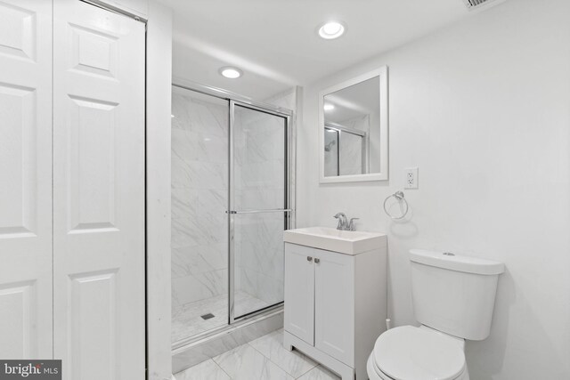 bathroom featuring vanity, recessed lighting, a shower stall, and toilet