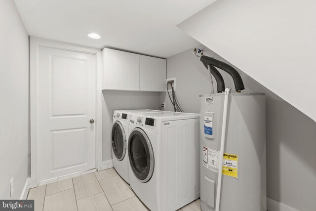 laundry area featuring washing machine and clothes dryer, baseboards, recessed lighting, water heater, and laundry area