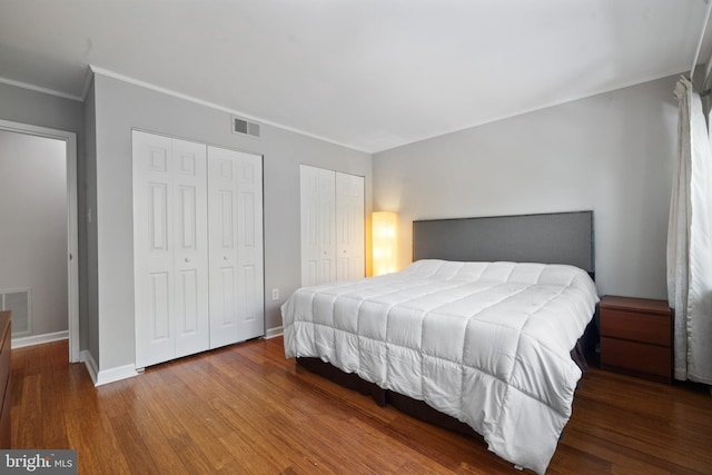 18 Canterbury Sq Unit 302, Alexandria, VA 22304 - bedroom featuring visible vents, ornamental molding, two closets, and wood finished floors