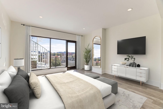 bedroom featuring recessed lighting, baseboards, and light wood-type flooring
