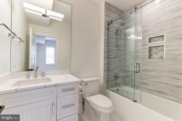 full bath featuring enclosed tub / shower combo, toilet, and vanity