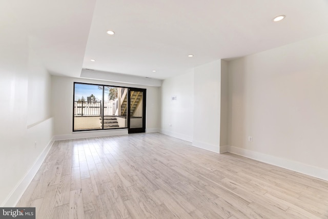 unfurnished room featuring baseboards, recessed lighting, and light wood finished floors