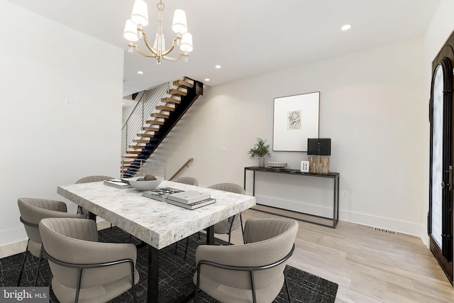 dining room featuring visible vents, recessed lighting, light wood finished floors, a notable chandelier, and stairs