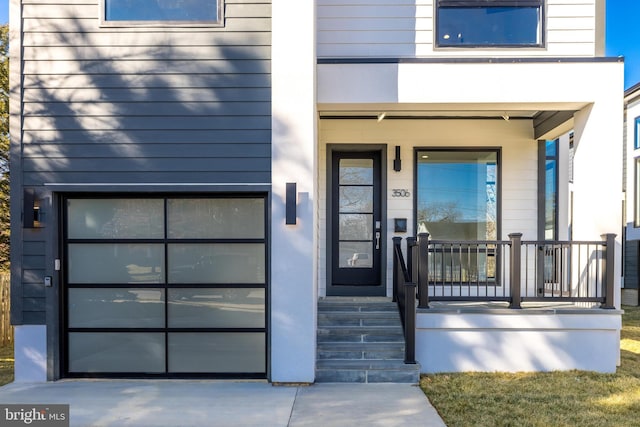 3506 Lake St, Falls Church, VA 22041 - view of exterior entry with covered porch, concrete driveway, and a garage