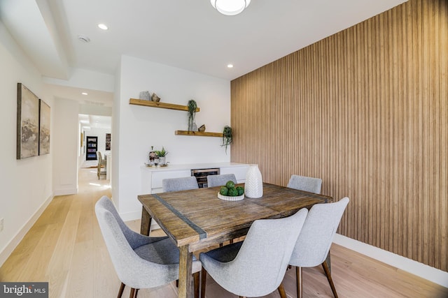 dining room with recessed lighting, light wood finished floors, and baseboards