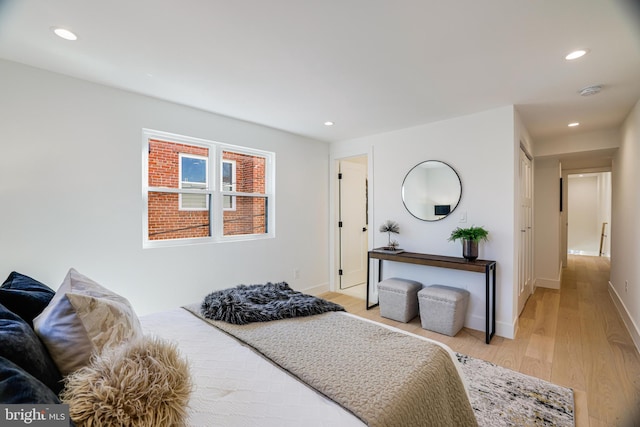 bedroom featuring light wood finished floors, baseboards, and recessed lighting