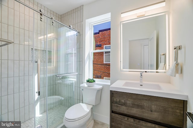 full bath with vanity, a shower stall, and toilet