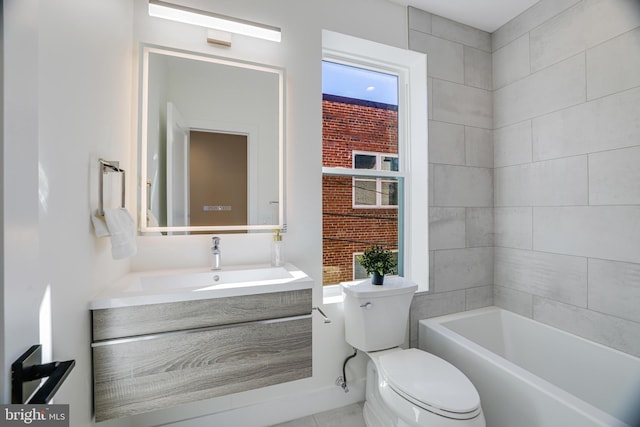 full bath featuring a tub to relax in, toilet, and vanity