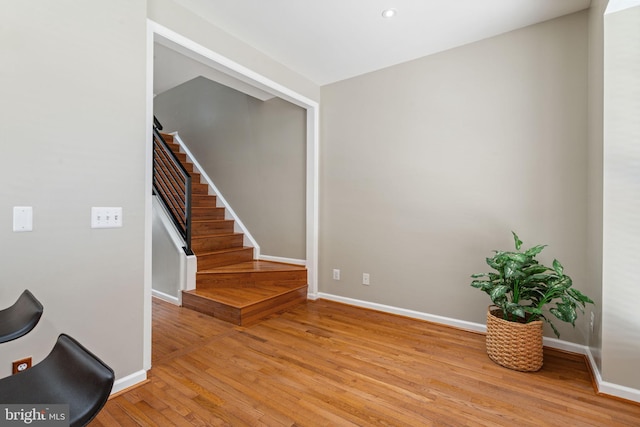 foyer featuring stairway, baseboards, recessed lighting, and light wood finished floors