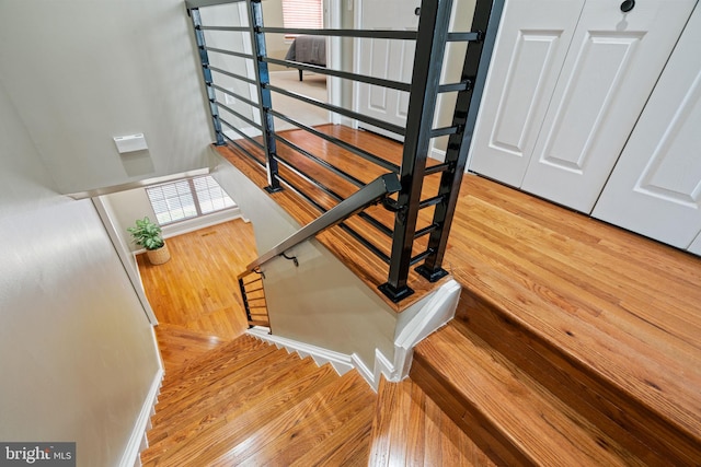 stairway featuring wood finished floors