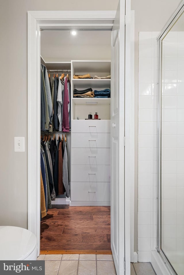 walk in closet with tile patterned flooring