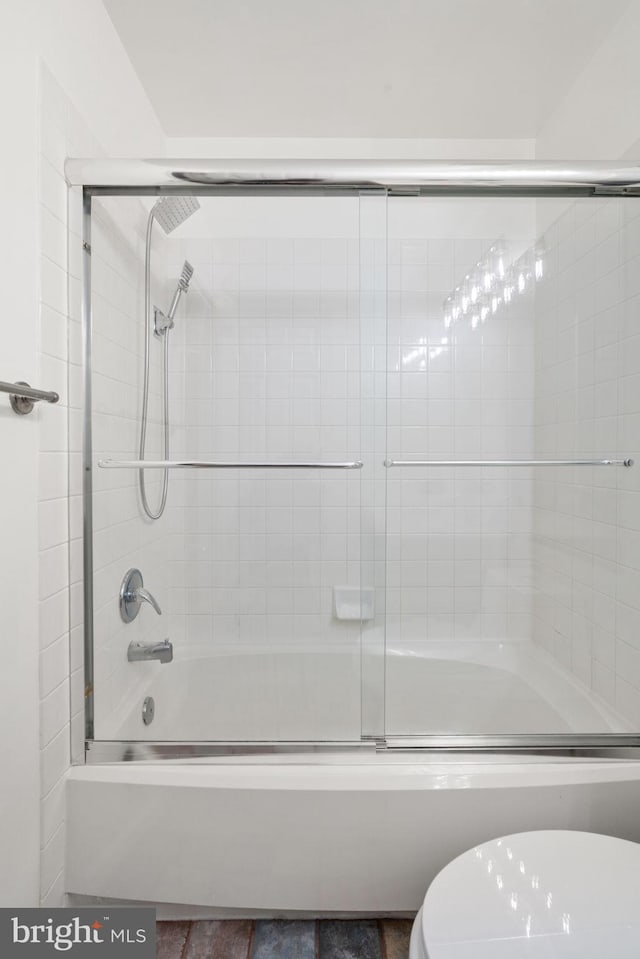 full bath with bath / shower combo with glass door and toilet