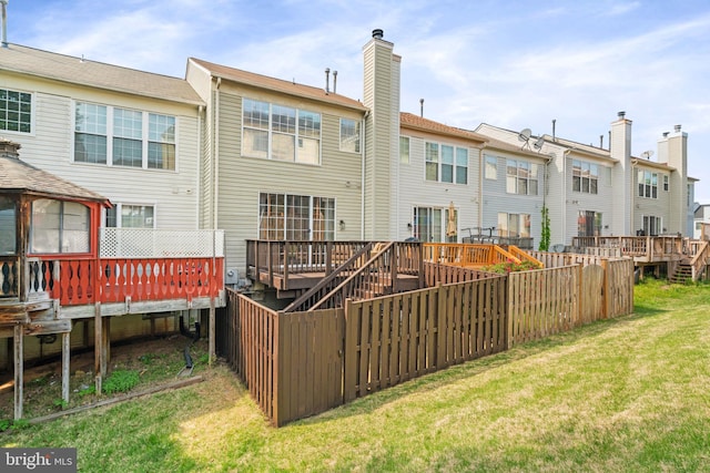16857 Jed Forest Ln, Woodbridge, VA 22191 - rear view of property with a chimney, a lawn, a residential view, a wooden deck, and fence