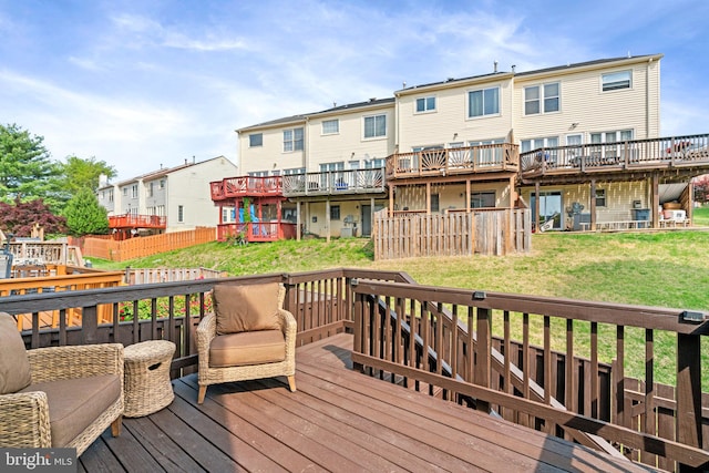 wooden terrace with a lawn and a residential view