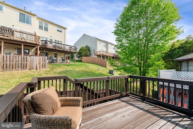 wooden terrace with a lawn and a residential view