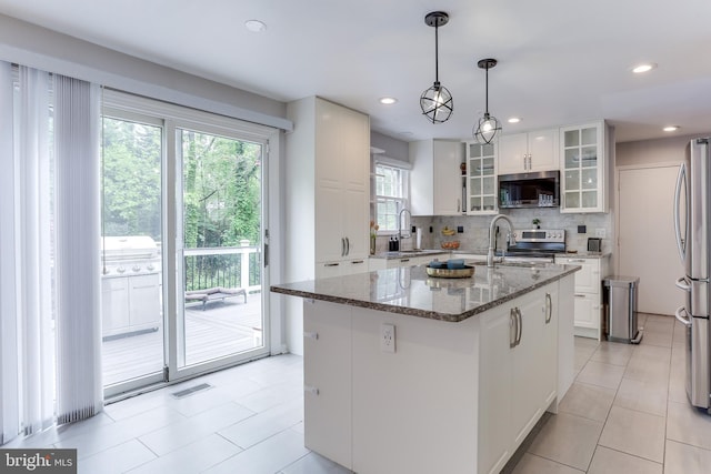 4011 Hummer Rd, Annandale, VA 22003 - kitchen with appliances with stainless steel finishes, a sink, tasteful backsplash, white cabinetry, and dark stone countertops