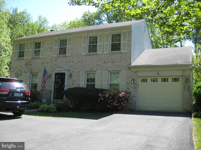 4011 Hummer Rd, Annandale, VA 22003 - colonial inspired home featuring a garage, driveway, and brick siding