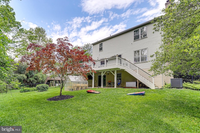4011 Hummer Rd, Annandale, VA 22003 - back of house featuring a greenhouse, stairway, an outdoor structure, a deck, and cooling unit