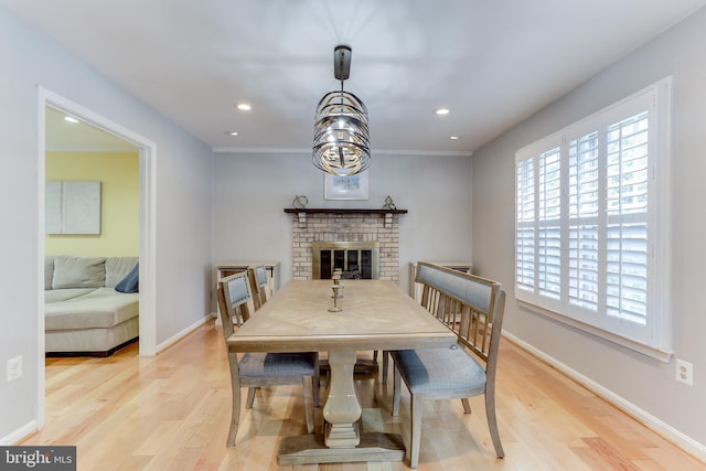 4011 Hummer Rd, Annandale, VA 22003 - dining space featuring light wood-style floors, recessed lighting, a fireplace, baseboards, and crown molding