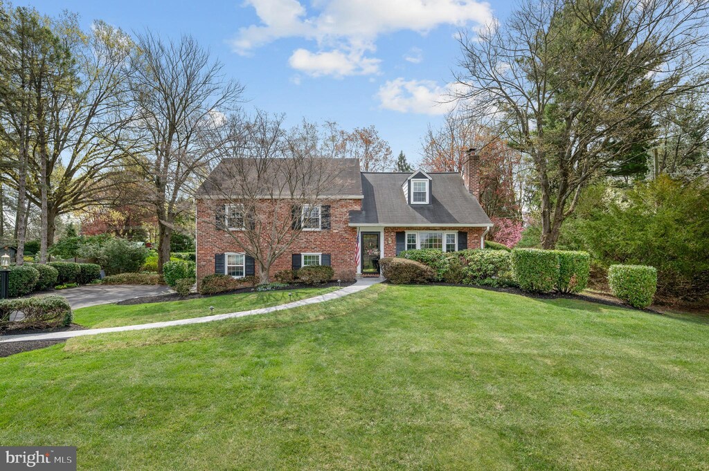 21 Clover Ln, Malvern, PA 19355 - view of front of home featuring a chimney, a front lawn, and brick siding