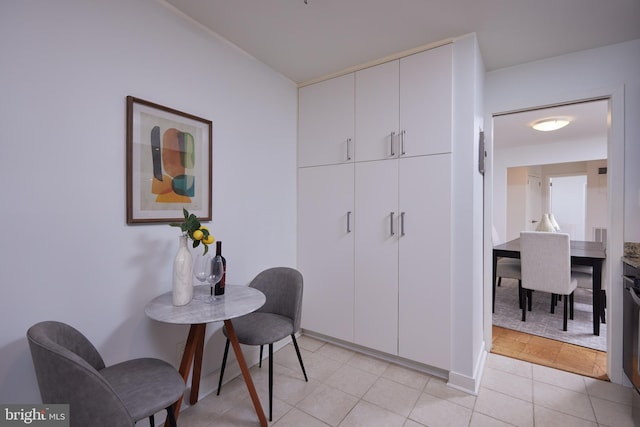 interior space featuring baseboards and light tile patterned flooring
