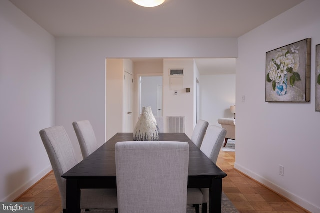 dining space featuring baseboards and visible vents