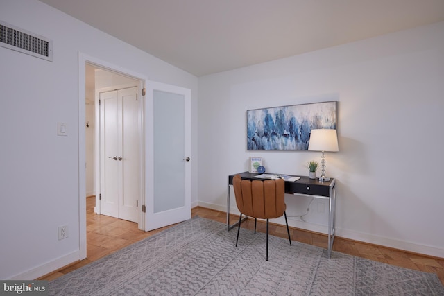 office area featuring baseboards and visible vents