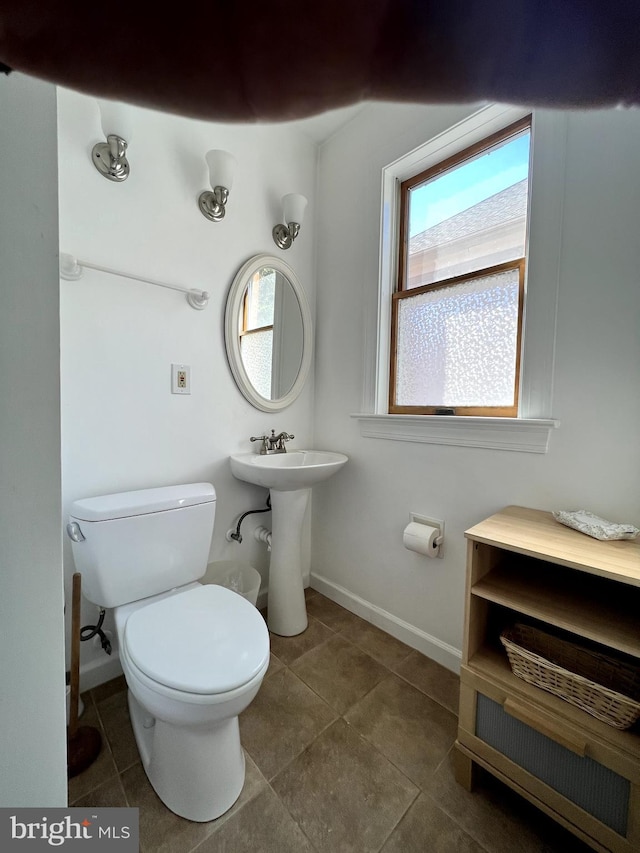 3903 8th St S, Arlington, VA 22204 - half bath with plenty of natural light, toilet, baseboards, and tile patterned floors