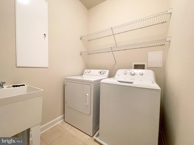3648 Holborn Pl Unit 3648, Frederick, MD 21704 - clothes washing area with a sink, washing machine and dryer, baseboards, laundry area, and light tile patterned floors