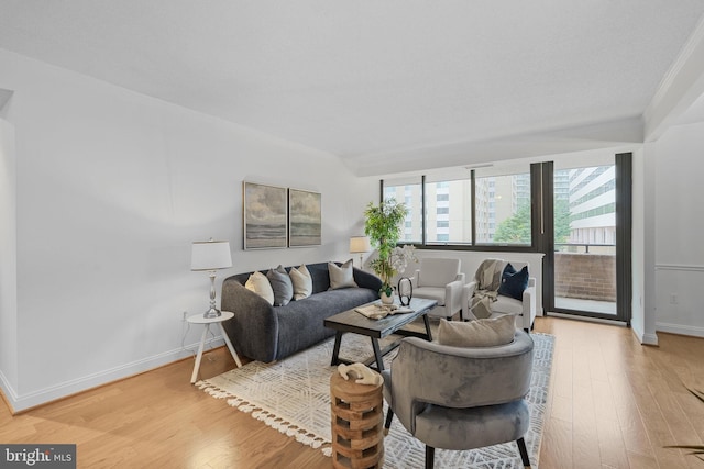 living area with light wood-style flooring and baseboards