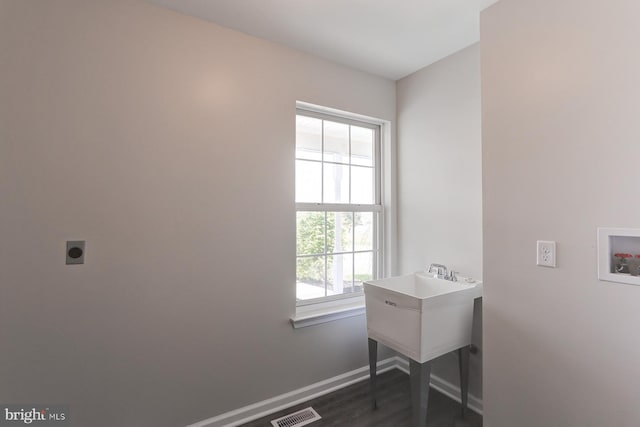 clothes washing area featuring dark wood-style flooring, laundry area, hookup for a washing machine, electric dryer hookup, and visible vents