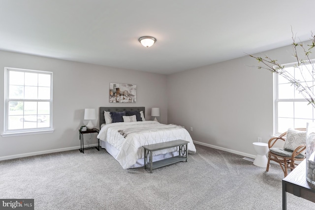 bedroom with carpet floors and baseboards