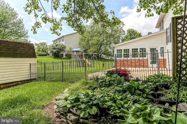 view of yard featuring a playground and fence