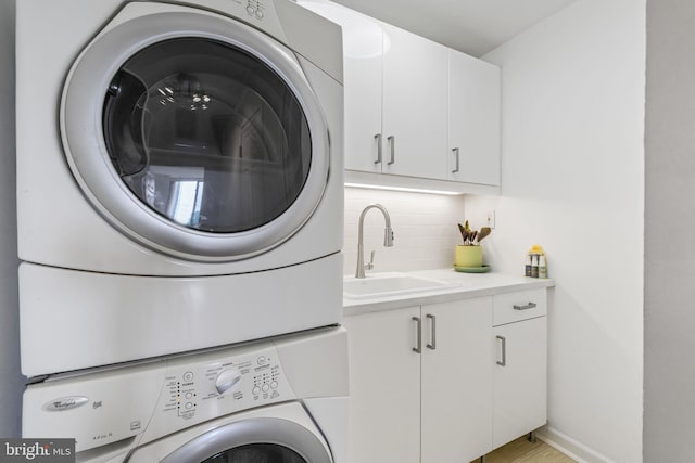 4620 N Park Ave Unit 1508E, Chevy Chase, MD 20815 - laundry area featuring stacked washer / dryer and cabinet space