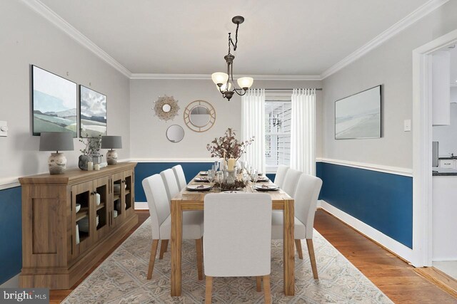 4500 Hadrian Ct, Alexandria, VA 22310 - dining space featuring a chandelier, crown molding, wood finished floors, and baseboards