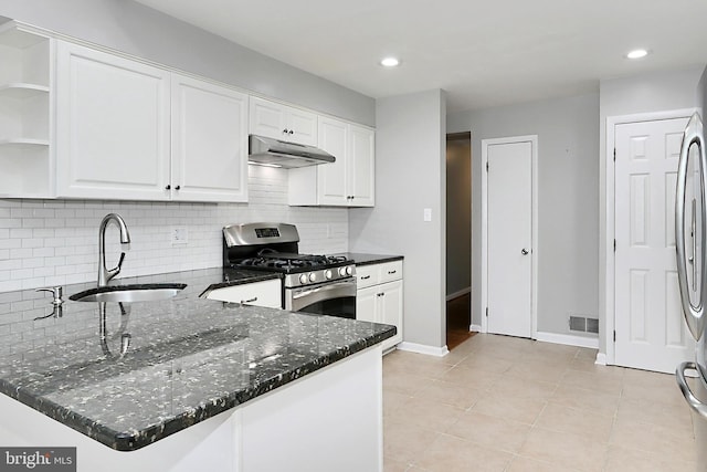 4500 Hadrian Ct, Alexandria, VA 22310 - kitchen featuring stainless steel gas range oven, a sink, under cabinet range hood, white cabinetry, and dark stone countertops