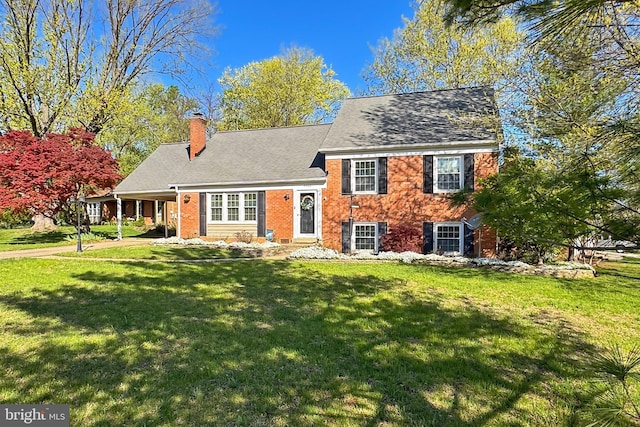 4500 Hadrian Ct, Alexandria, VA 22310 - tri-level home with a front yard, a chimney, brick siding, and driveway