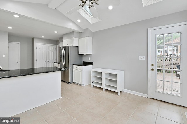 4500 Hadrian Ct, Alexandria, VA 22310 - kitchen featuring a skylight, a ceiling fan, stainless steel refrigerator with ice dispenser, white cabinets, and light tile patterned floors