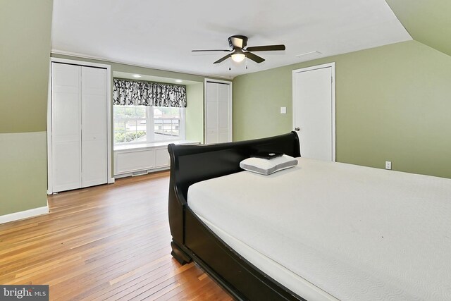 4500 Hadrian Ct, Alexandria, VA 22310 - bedroom with two closets, light wood-style floors, lofted ceiling, and ceiling fan