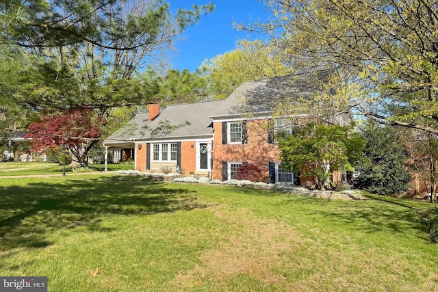 4500 Hadrian Ct, Alexandria, VA 22310 - split level home with a front yard, a chimney, and brick siding