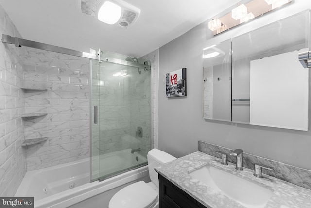 bathroom featuring vanity, enclosed tub / shower combo, and toilet