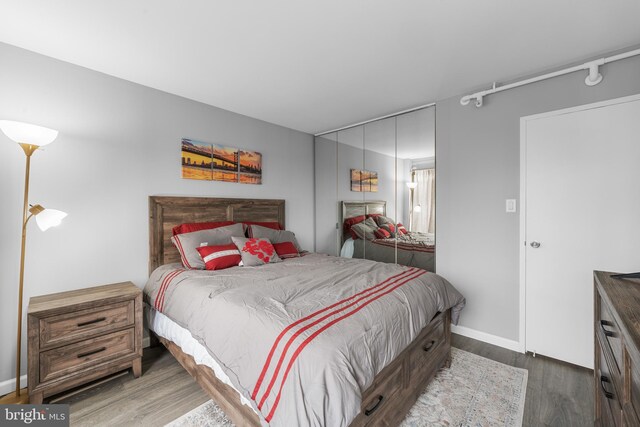 bedroom featuring baseboards and wood finished floors