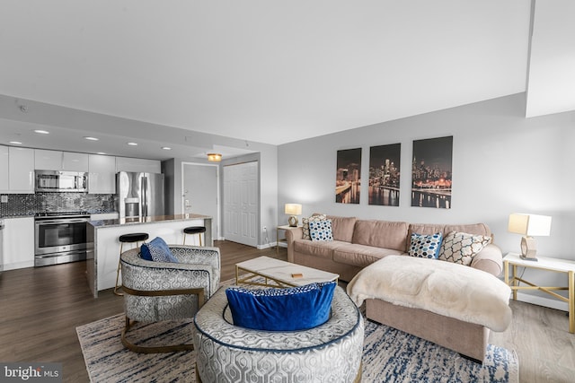 living area with baseboards, recessed lighting, and dark wood finished floors