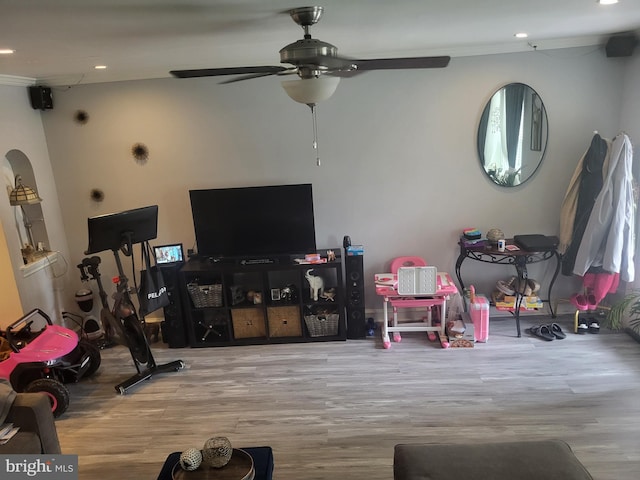 playroom with recessed lighting, wood finished floors, a ceiling fan, and ornamental molding