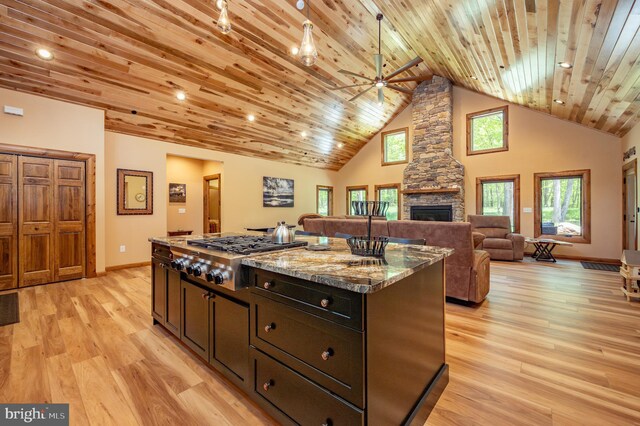 17 Green Jacket Ct, Mc Henry, MD 21541 - kitchen featuring stainless steel gas cooktop, ceiling fan, a fireplace, light wood finished floors, and a center island